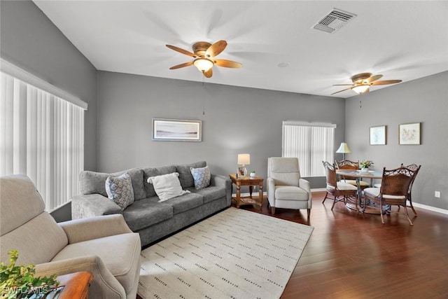 living room featuring hardwood / wood-style floors and ceiling fan