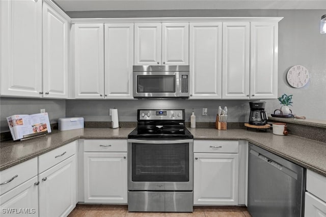 kitchen with appliances with stainless steel finishes and white cabinets