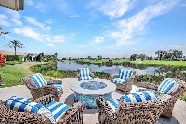 view of patio / terrace with a fire pit and a water view