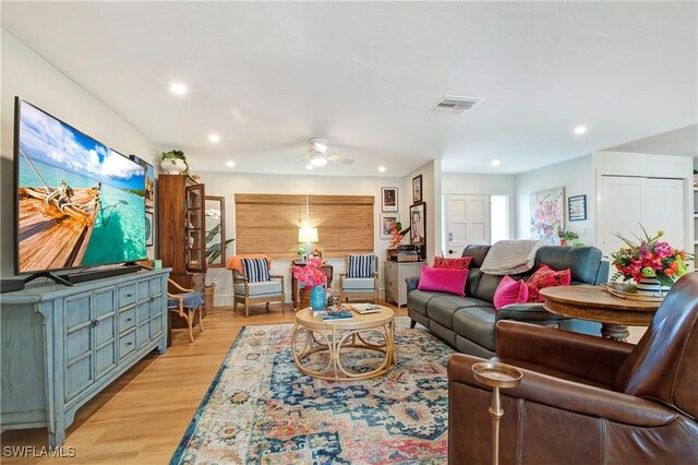 living room with ceiling fan and light wood-type flooring