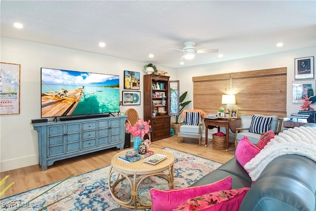 living room featuring ceiling fan and light hardwood / wood-style floors