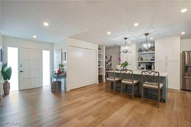 dining area featuring an inviting chandelier and light hardwood / wood-style floors