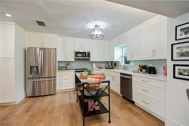 kitchen with appliances with stainless steel finishes and white cabinets