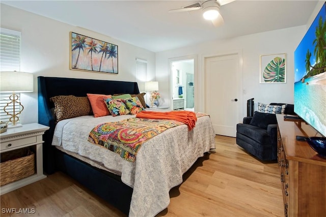 bedroom featuring ceiling fan, ensuite bath, and light hardwood / wood-style floors