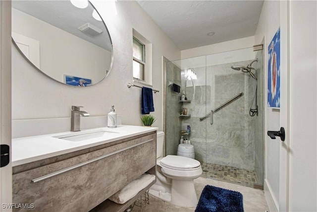 bathroom with tile patterned floors, vanity, toilet, and a shower with shower door