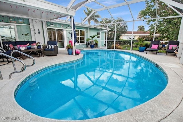 view of swimming pool with an outdoor living space, a lanai, and a patio area