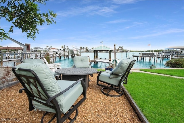 dock area with a water view and a lawn