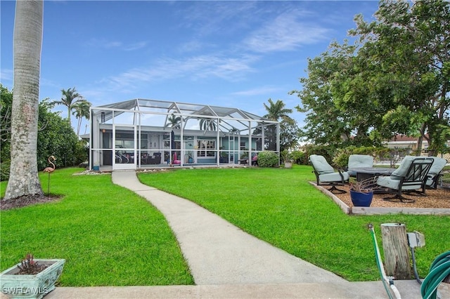 back of property featuring a lanai and a lawn