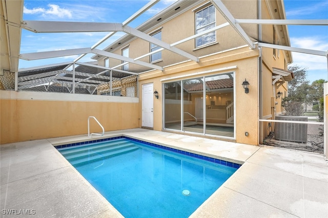 view of swimming pool with cooling unit, a lanai, and a patio