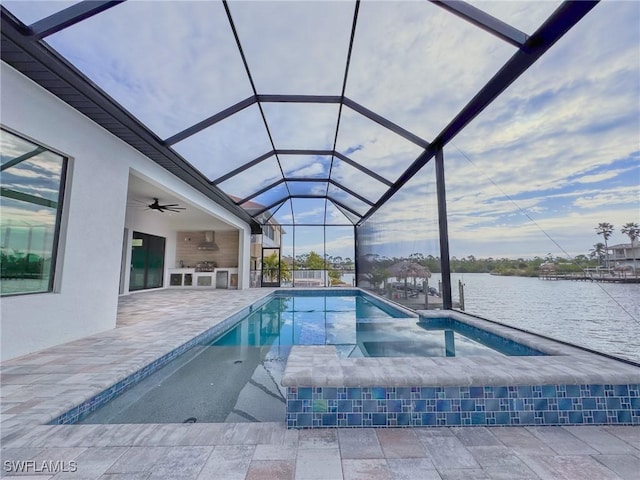 view of swimming pool with a patio, area for grilling, ceiling fan, glass enclosure, and a water view