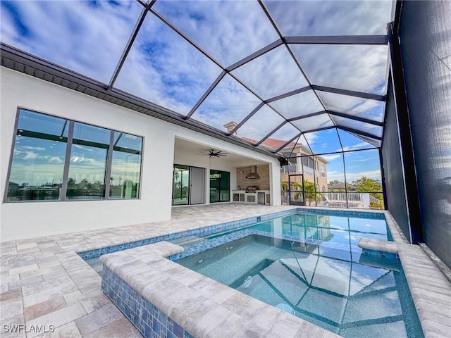 view of pool featuring an in ground hot tub, ceiling fan, a lanai, and a patio area