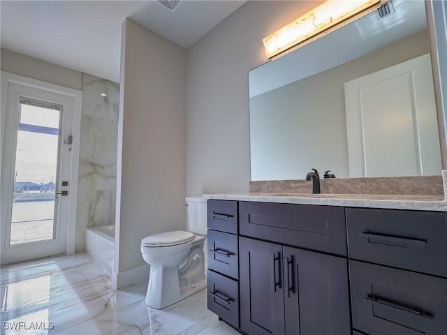 full bathroom featuring vanity, plenty of natural light, tiled shower / bath, and toilet