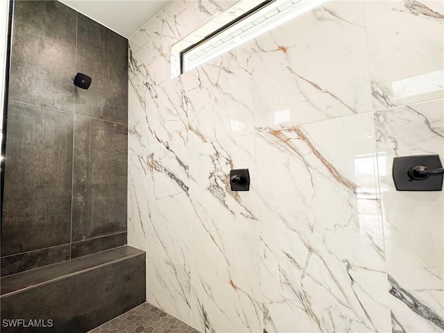 bathroom with a tile shower