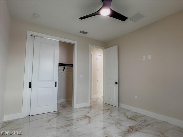 unfurnished bedroom with ceiling fan and a closet