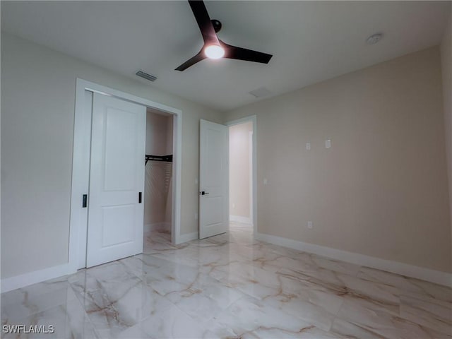 unfurnished bedroom with ceiling fan and a closet