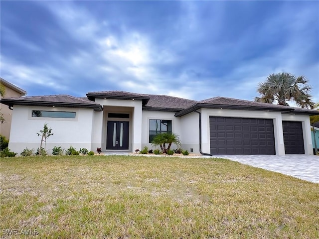 view of front of property with a garage and a front lawn