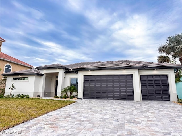 view of front facade with a garage and a front yard