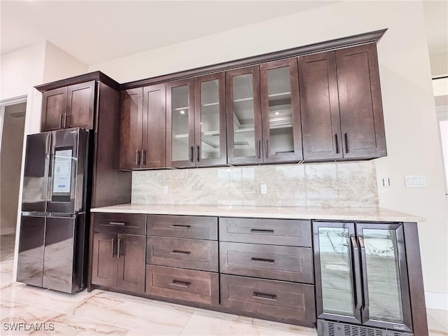 kitchen with stainless steel fridge, beverage cooler, dark brown cabinetry, and decorative backsplash