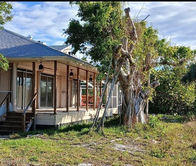 rear view of house featuring ceiling fan