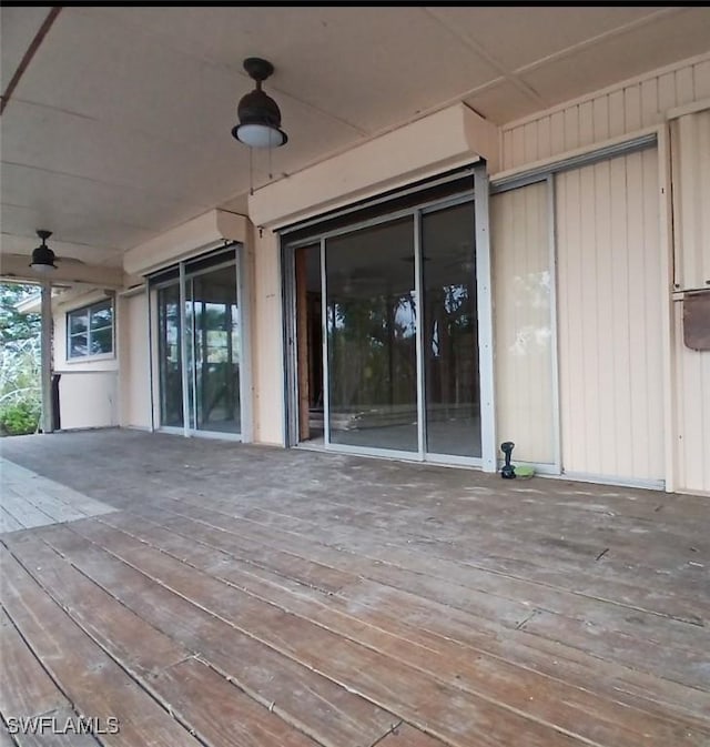 wooden terrace featuring ceiling fan