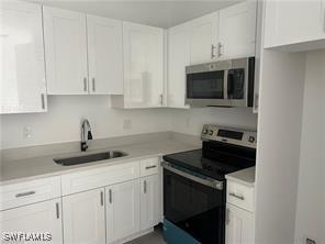 kitchen featuring white cabinetry, sink, and stainless steel appliances