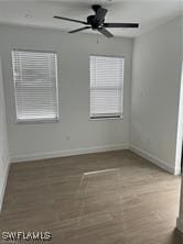 unfurnished room with hardwood / wood-style flooring and ceiling fan