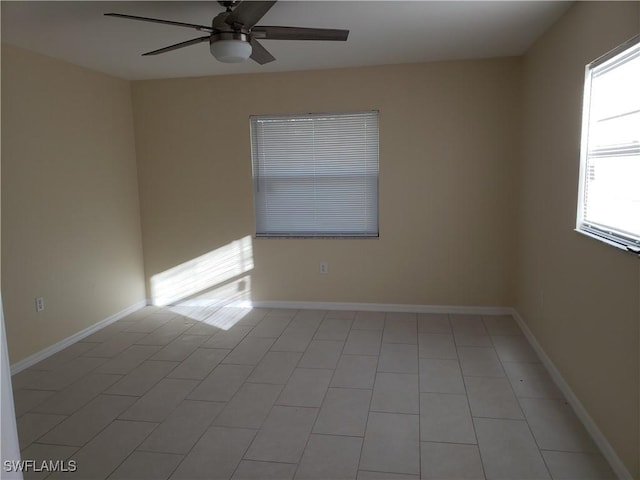 tiled spare room featuring ceiling fan