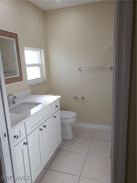 bathroom featuring vanity, toilet, and tile patterned flooring