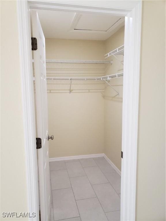 spacious closet with light tile patterned floors