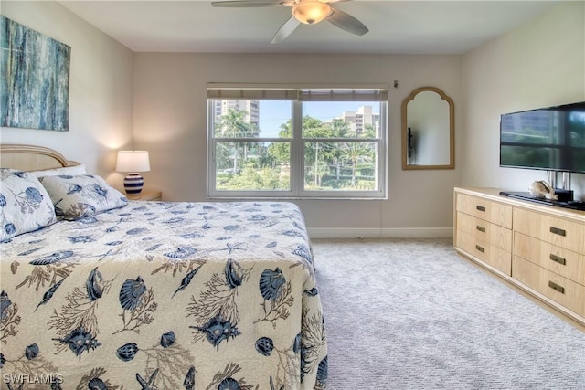 bedroom featuring light carpet and ceiling fan