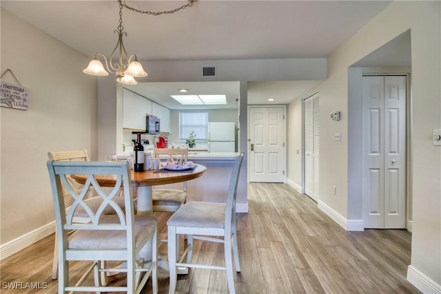 dining area with light hardwood / wood-style flooring