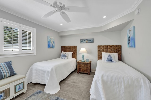 bedroom with crown molding, ceiling fan, and light hardwood / wood-style flooring