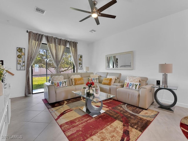 tiled living room with ceiling fan