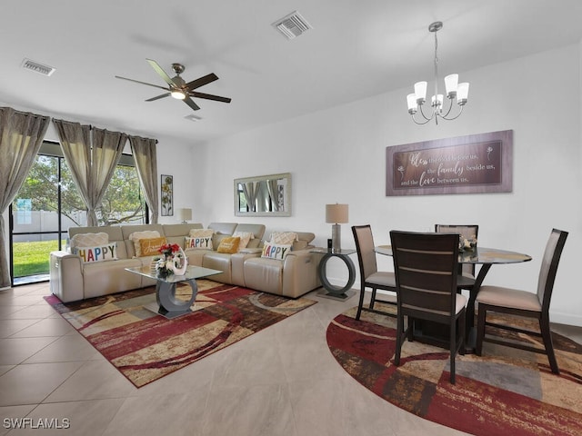 living room with ceiling fan with notable chandelier and tile patterned flooring