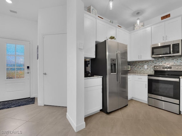 kitchen featuring stainless steel appliances, white cabinetry, and light tile patterned floors