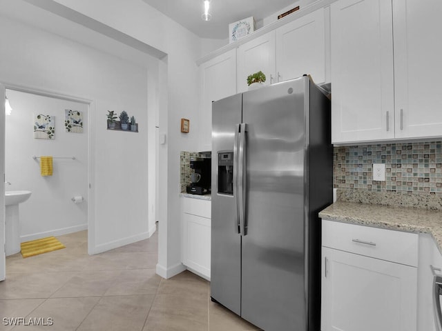 kitchen with tasteful backsplash, stainless steel fridge with ice dispenser, and white cabinets