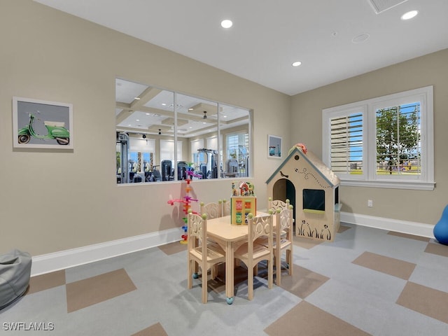 rec room featuring coffered ceiling and beam ceiling