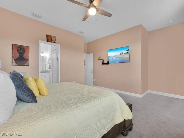 bedroom featuring connected bathroom, carpet floors, and ceiling fan