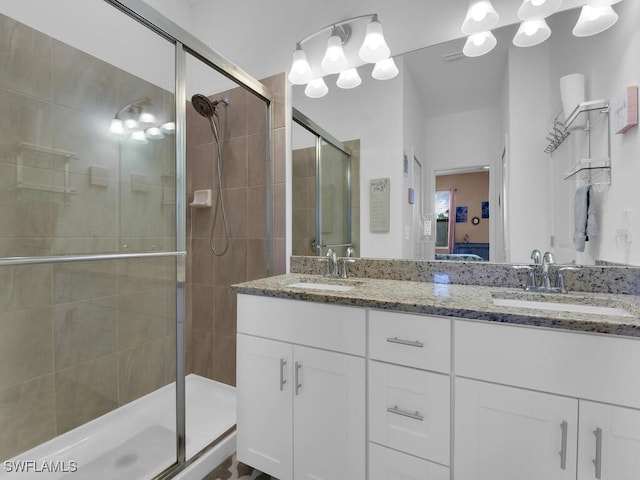 bathroom featuring vanity and a shower with shower door