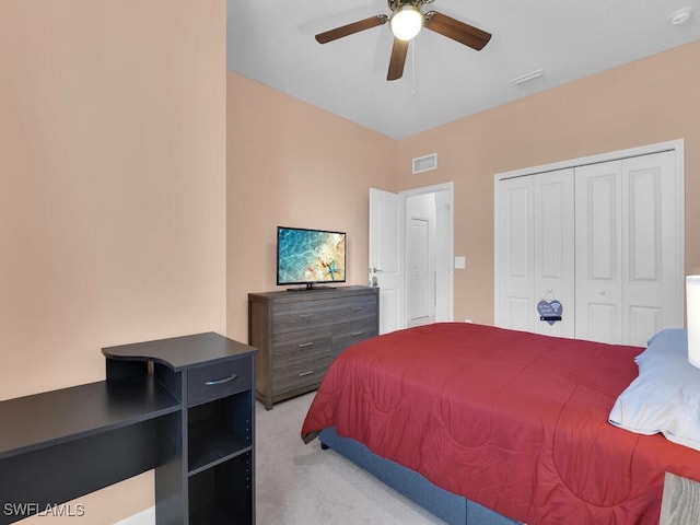 carpeted bedroom featuring a closet and ceiling fan