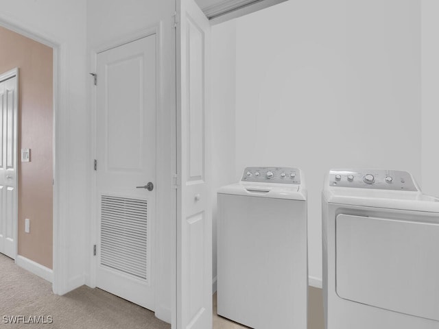 washroom featuring light colored carpet and washing machine and dryer