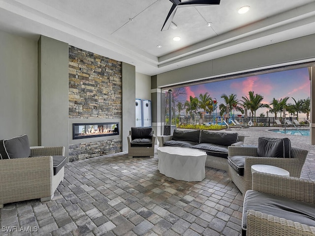 living room with a stone fireplace