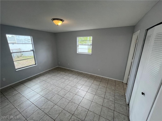 unfurnished bedroom with light tile patterned flooring