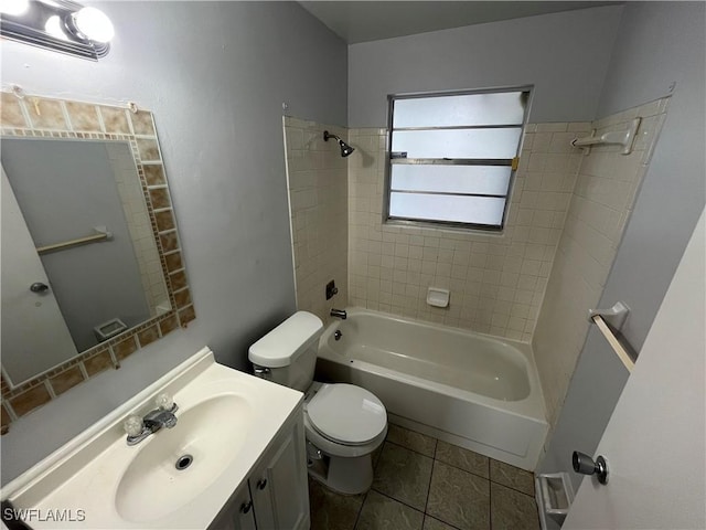 full bathroom featuring tiled shower / bath combo, vanity, tile patterned floors, and toilet