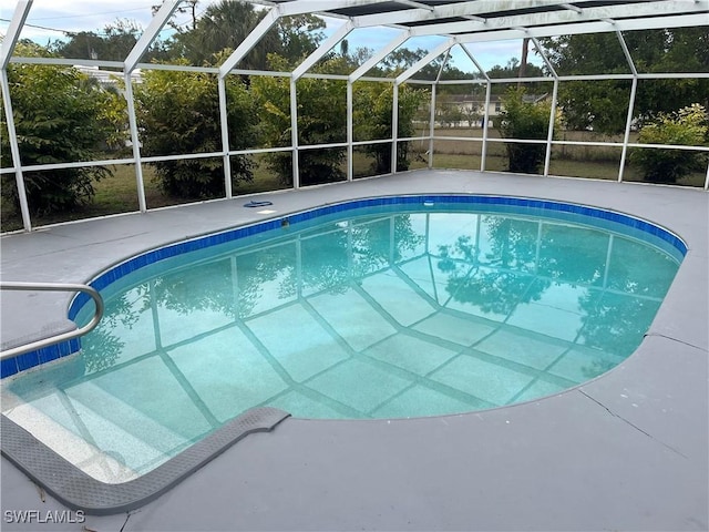 view of swimming pool with glass enclosure