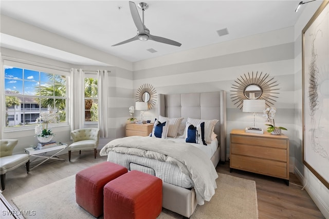 bedroom with wood-type flooring and ceiling fan