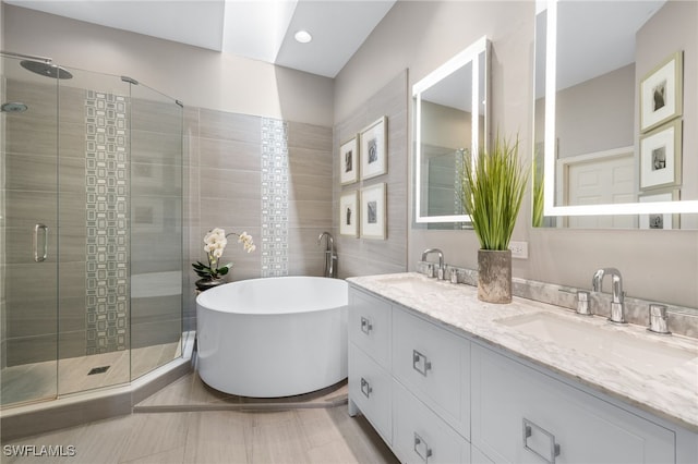 bathroom featuring vanity and shower with separate bathtub