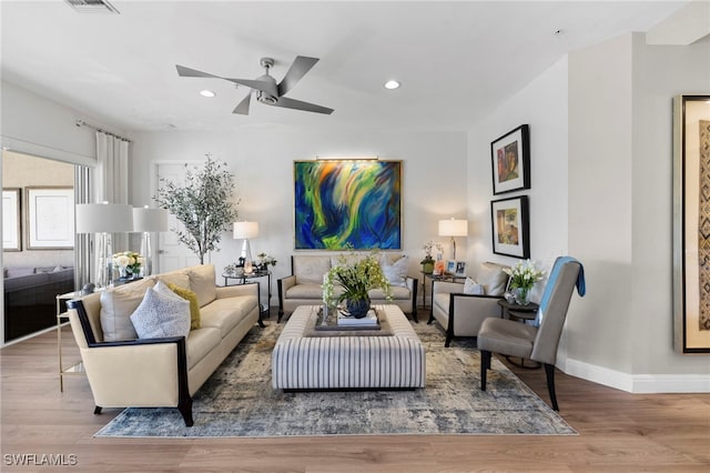 living room with wood-type flooring and ceiling fan