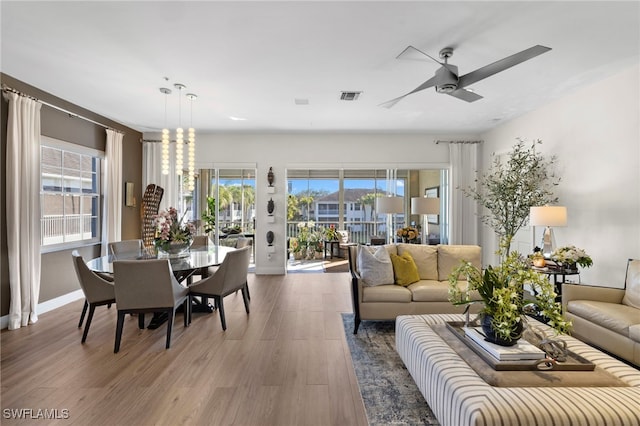 living room with ceiling fan and wood-type flooring