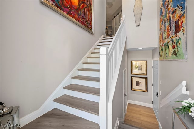 staircase featuring wood-type flooring